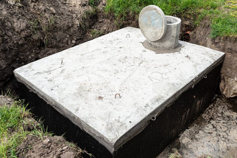 Concrete septic tank with a capacity of 10 cubic meters placed in the garden by the house.