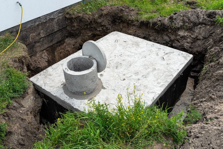 Best Excavating and Construction Contractor in Rutland Concrete septic tank with a capacity of 10 cubic meters placed in the garden by the house.